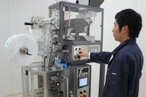 Fuso International&rsquo;s Yusuke Noda demonstrates Packmaster&rsquo;s new pyramid tea bag packaging equipment.